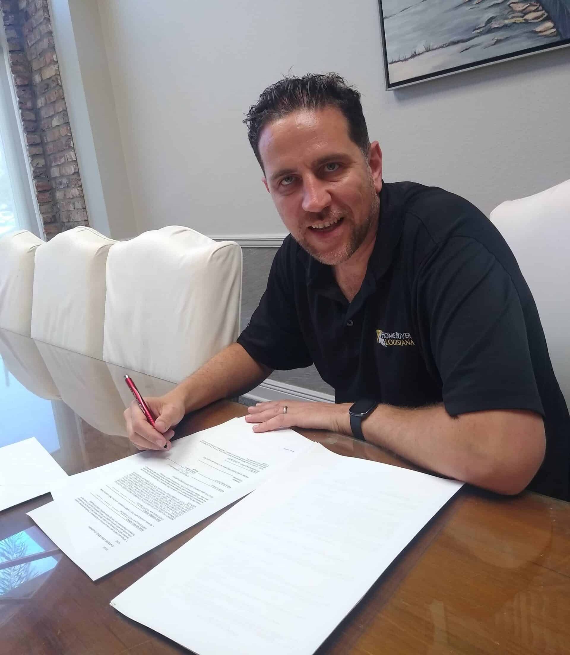 Stephen Keighery signing residential property closing documents as part of Home Buyer Louisiana’s structured capital framework