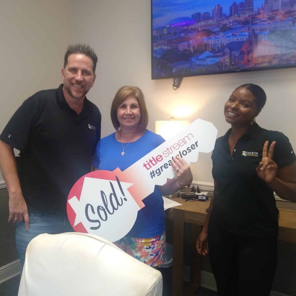 Louisiana homeowner celebrating a cash home sale with the Home Buyer Louisiana team at a local title company